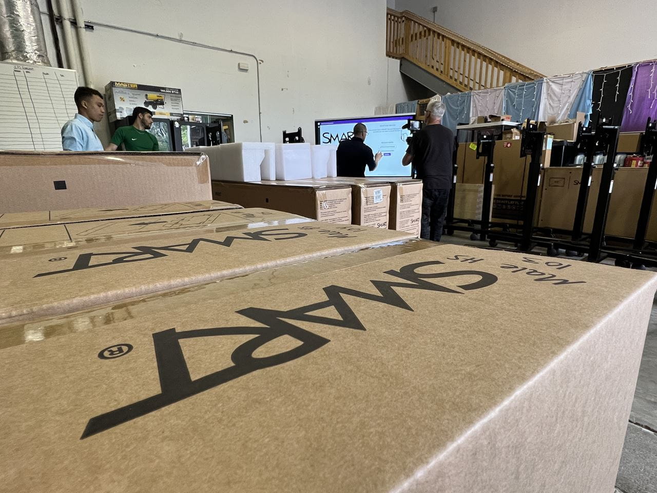 Boxes labeled SMART being unpacked in a warehouse during installation.