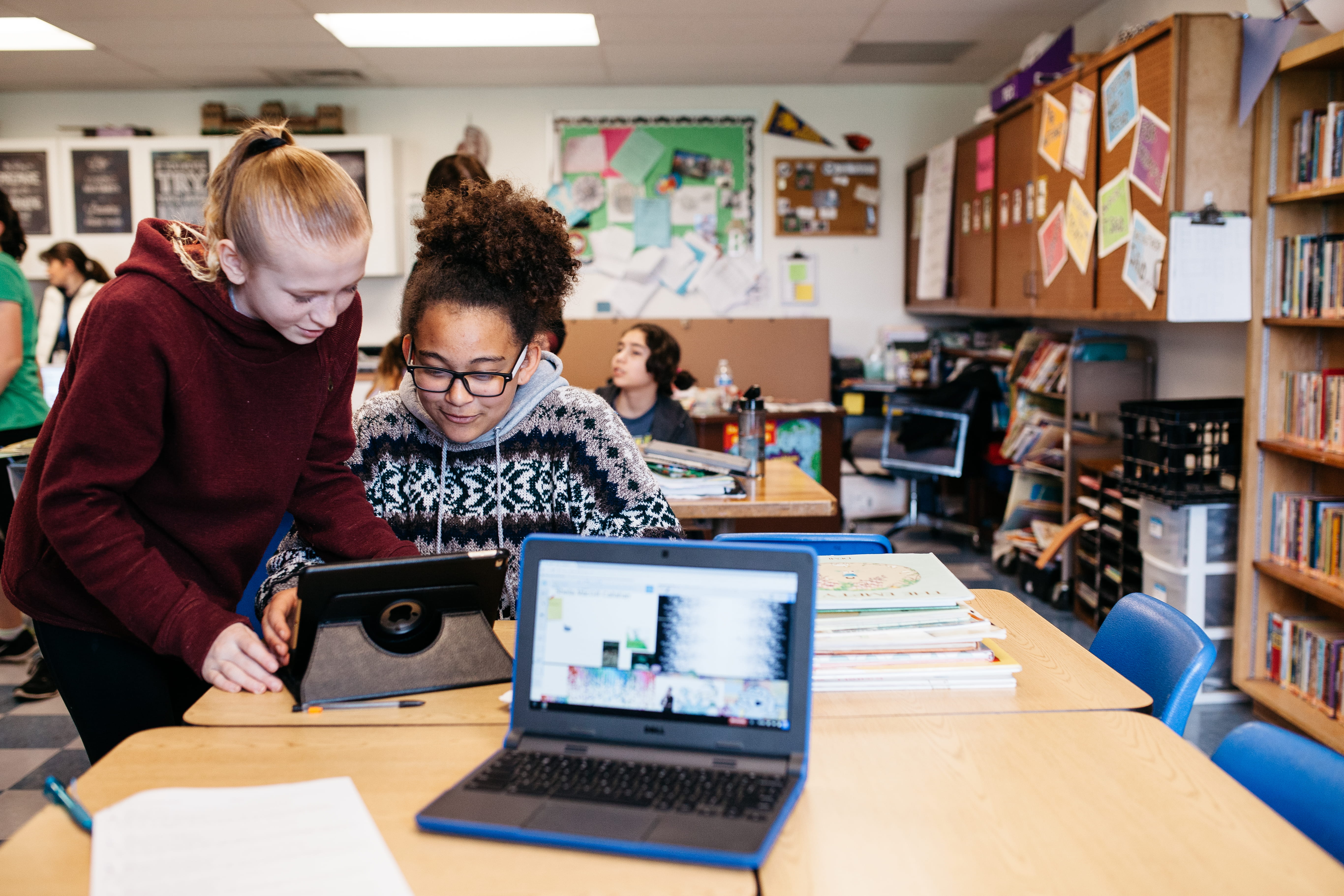 Two students working collaboratively on a tablet